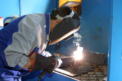 A worker welding some iron