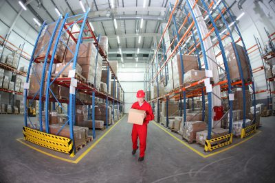 worker in red uniform with box in the warehouse in fish-eye lens