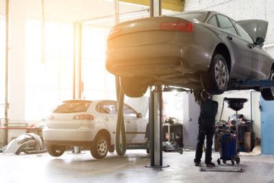 Vehicle raised on lift at maintenance station