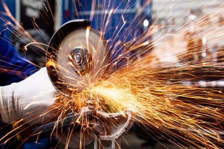 man cutting metal