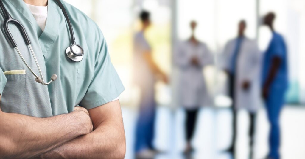 doctors faded in background, concept of Managing Healthcare Risks with Effective EH&S