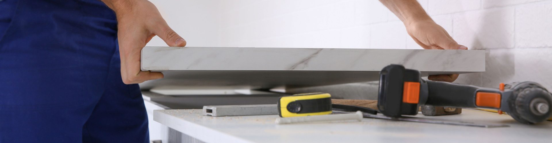 worker doing countertop fabrication and installation, representing silica exposure and hazard risks